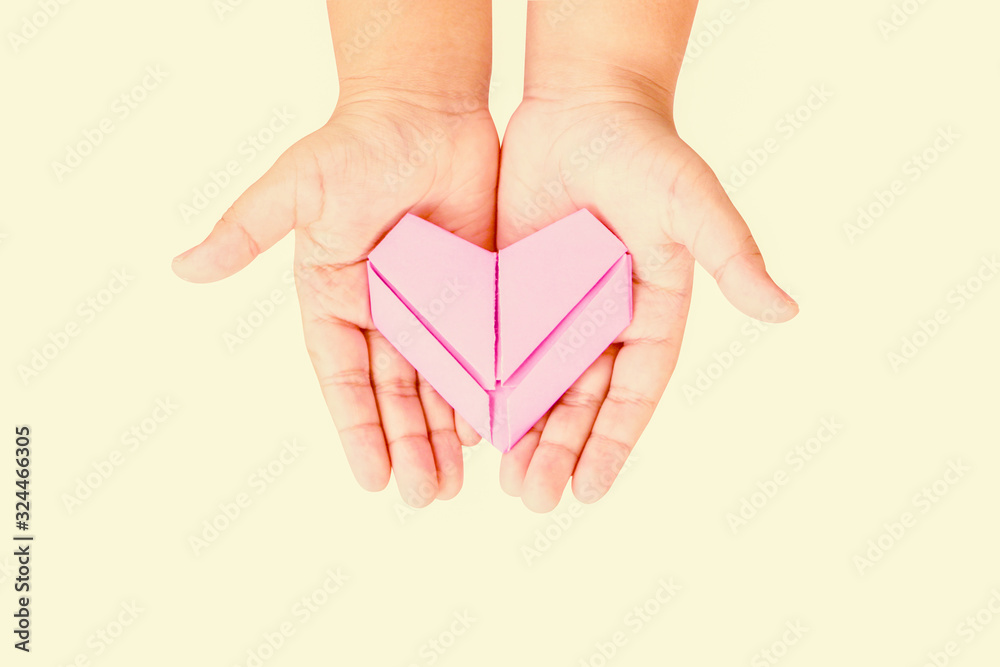 Paper hearts in children hands on isolated backgrounds