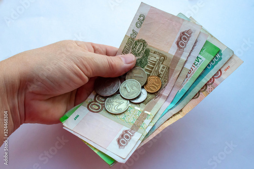 The hand of an elderly woman with coins, Rubles from pensioner
