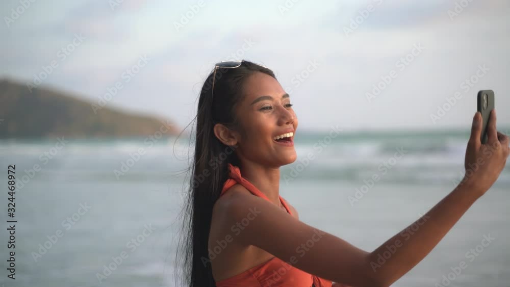 Beautiful sexy bikini african woman black skin taking selfie photos using smartphone on the beach sunset 4K Resolution Beautiful sexy bikini african woman black skin taking selfie photos using smartphone on the beach sunset 4K Resolution