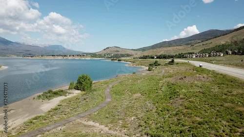 wide rising aerial shot over a lake in a mountain valley, colorado USA photo