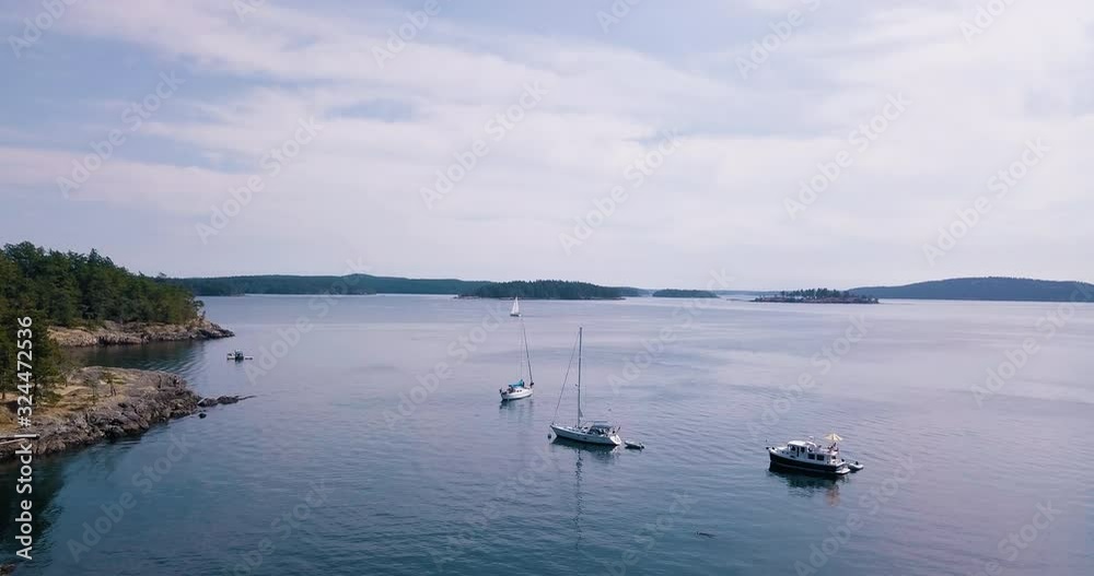 Wide drone over sailboats in cove in Jones Island Washington Wide drone over sailboats in cove in Jones Island Washington