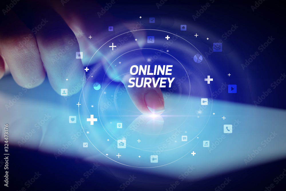 Finger touching tablet with social media icons and ONLINE SURVEY Finger touching tablet with social media icons and ONLINE SURVEY