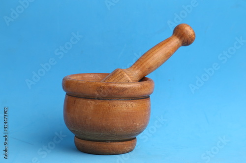 cooking wooden mortar in color background