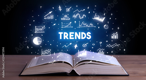 TRENDS inscription coming out from an open book, business concept photo