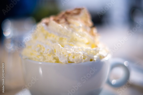 White cup of cocoa with cream