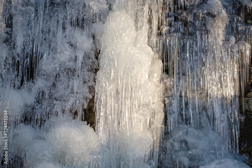 Beautiful ice candles on a frozen waterfall
