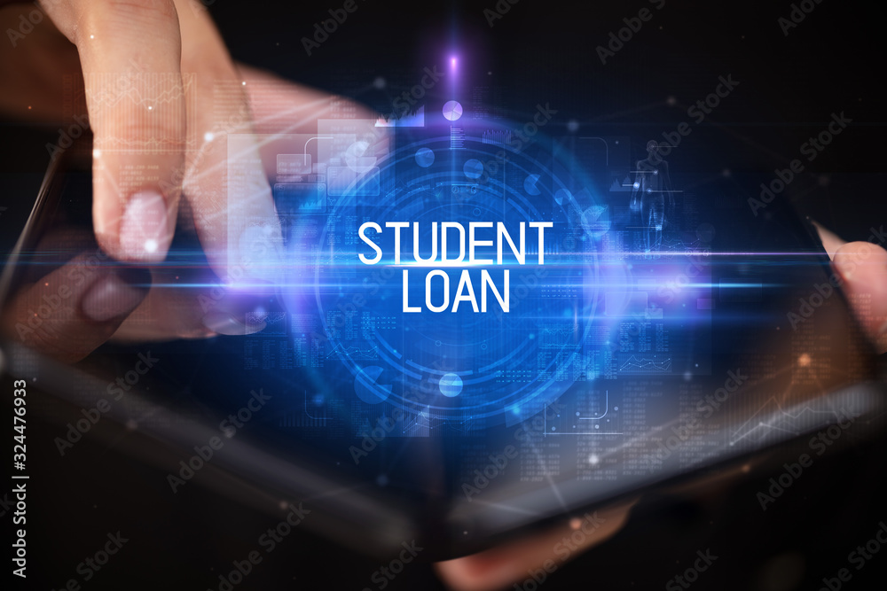 Young man holding a foldable smartphone with STUDENT LOAN inscription, educational concept Young man holding a foldable smartphone with STUDENT LOAN inscription, educational concept