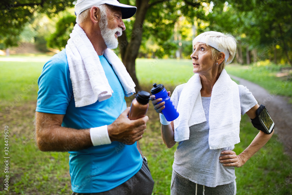 Obraz premium Active mature couple running in the park for helathy life