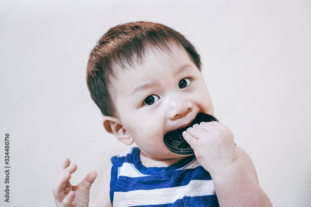 Portrait of The baby bites something with a seriously facial expression. Portrait of The baby bites something with a seriously facial expression.