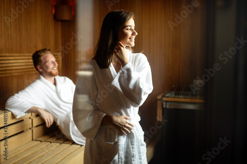 Beautiful couple relaxing in sauna and caring about health and skin