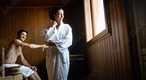 Happy couple having a steam bath in a sauna