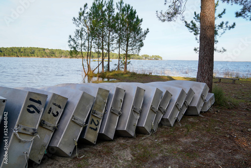 small learning school boat overturned Rowboats On Dock sand lake beach photo