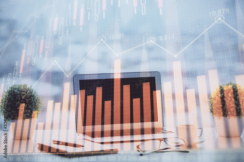 Stock market chart hologram drawn on personal computer background. Double exposure. Concept of investment. Stock market chart hologram drawn on personal computer background. Double exposure. Concept of investment.