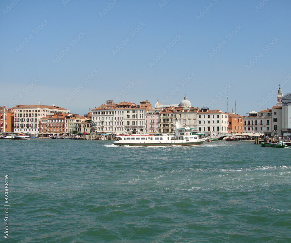 The beauty of the unique Venetian architecture surrounded by water streets and avenues against a clear blue summer sky.