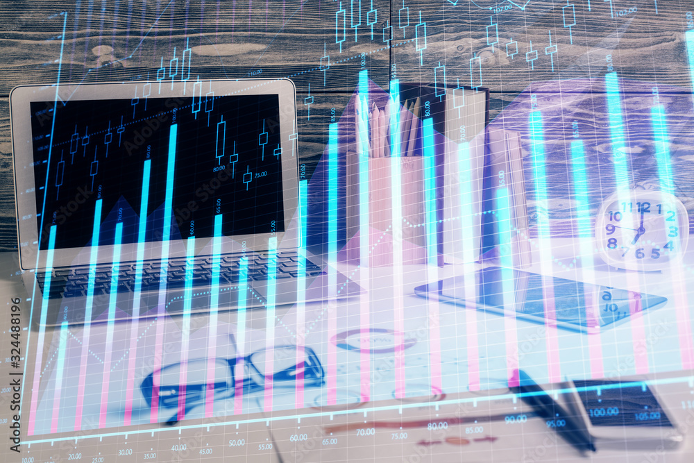 Double exposure of graph and financial info and work space with computer background. Concept of international online trading.