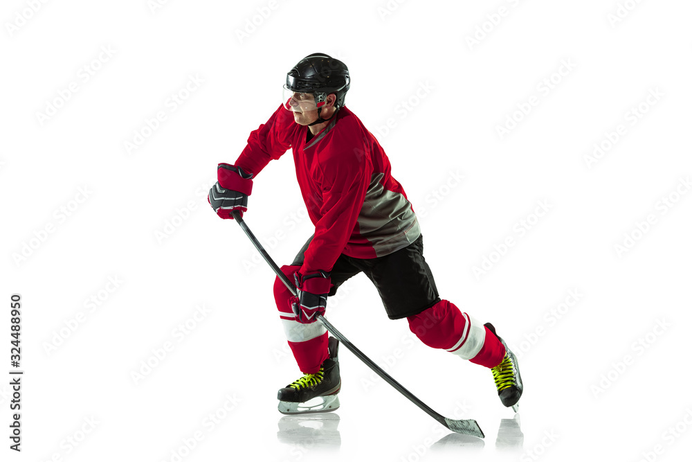 Obraz premium Leader. Male hockey player with the stick on ice court and white background. Sportsman wearing equipment and helmet practicing. Concept of sport, healthy lifestyle, motion, movement, action.