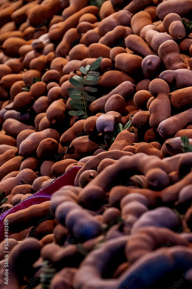 The background image of the ripe sweet tamarind pile