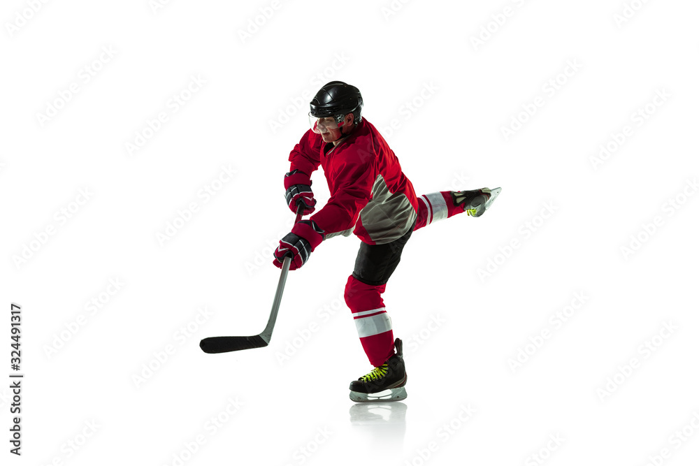 Fototapeta premium Leader. Male hockey player with the stick on ice court and white background. Sportsman wearing equipment and helmet practicing. Concept of sport, healthy lifestyle, motion, movement, action.