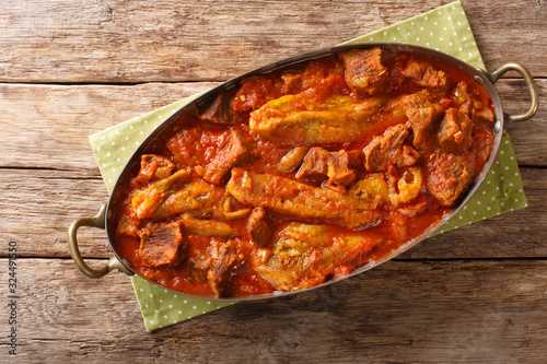 khoresh bademjan, Persian eggplant, meat and tomato stew braised with spices close-up in a pan. Horizontal top view photo