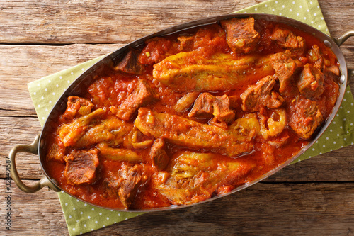 Khoresh Bademjan Slowly stewed lamb meat with eggplant, spices close-up in a pan. Horizontal top view photo