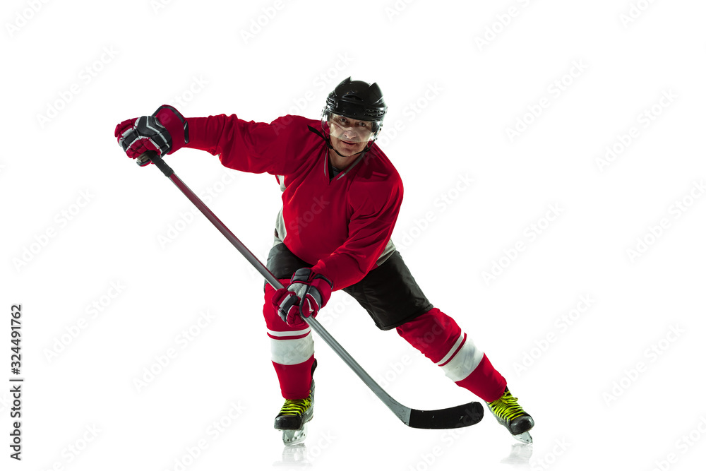 Fototapeta premium Scoring a goal. Male hockey player with the stick on ice court and white background. Sportsman wearing equipment and helmet practicing. Concept of sport, healthy lifestyle, motion, movement, action.