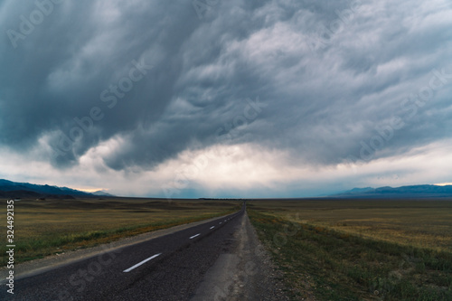 Lonely road in Kazajistan with clouds