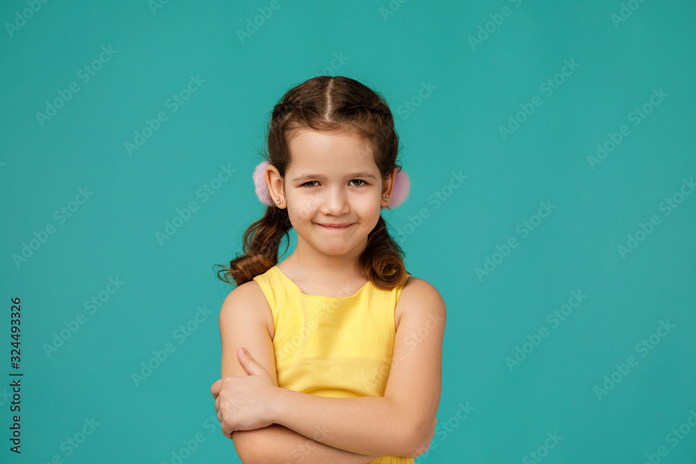 Cute smiling little child girl looking to camera on pink background. Human emotions and facial expression Cute smiling little child girl looking to camera on pink background. Human emotions and facial expression
