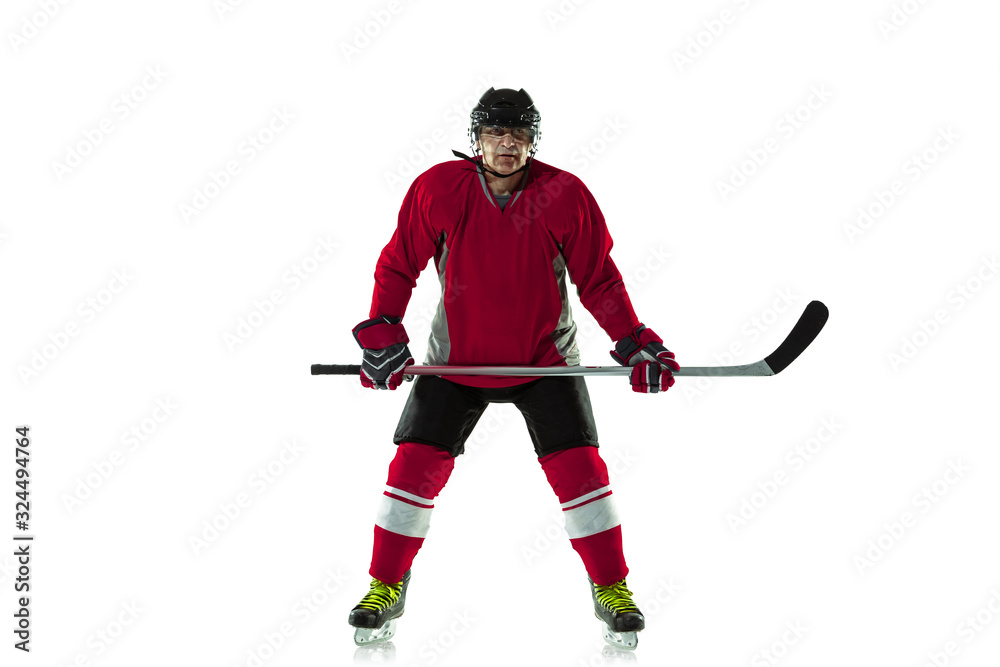 Activity. Male hockey player with the stick on ice court and white background. Sportsman wearing equipment and helmet practicing. Concept of sport, healthy lifestyle, motion, movement, action. Activity. Male hockey player with the stick on ice court and white background. Sportsman wearing equipment and helmet practicing. Concept of sport, healthy lifestyle, motion, movement, action.