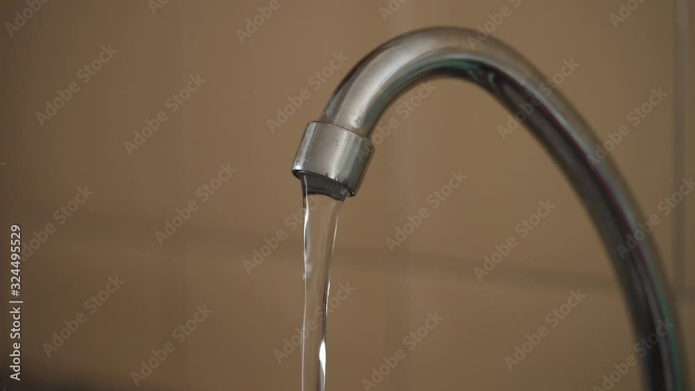 Kitchen faucet streaming clean water at half pressure Kitchen faucet streaming clean water at half pressure