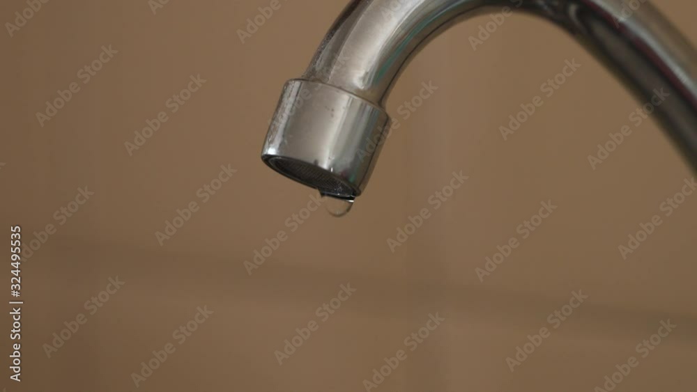 Kitchen faucet leaking clean water at high rate close-up Kitchen faucet leaking clean water at high rate close-up