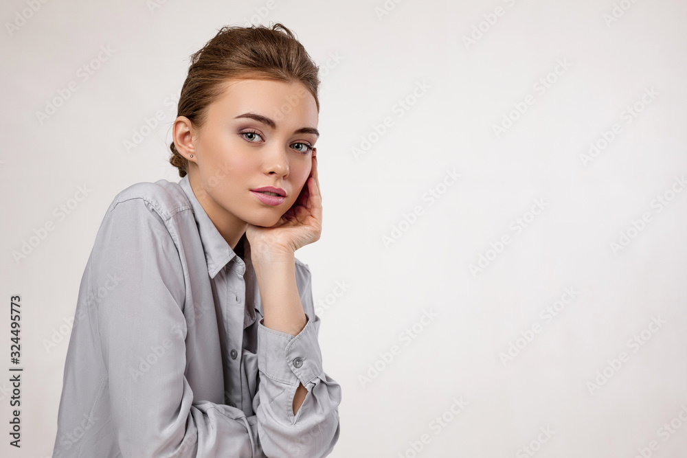 fashion portrait of beautiful tender woman in shirt on gray background. girl with perfect skin and make-up. copy space fashion portrait of beautiful tender woman in shirt on gray background. girl with perfect skin and make-up. copy space