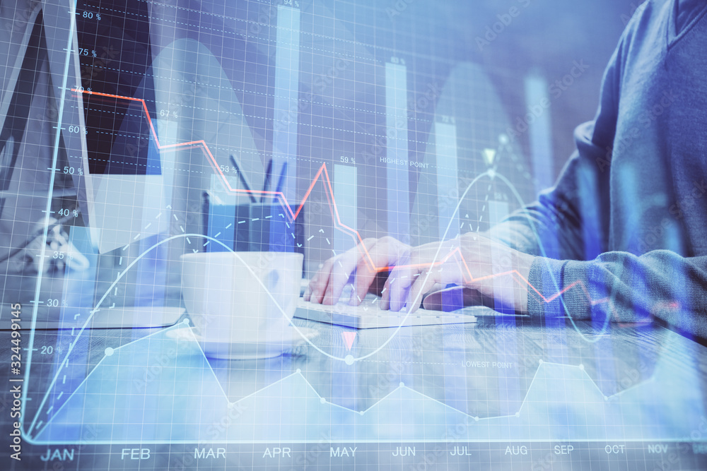 Multi exposure of graph with man typing on computer in office on background. Concept of hard work. Multi exposure of graph with man typing on computer in office on background. Concept of hard work.