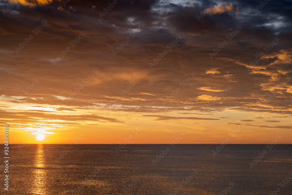 Fototapeta premium Early sunrise and epic cloudy sky above the sea. Coast of Torrevieja, Alicante, Spain. Mediterranean sea 2019