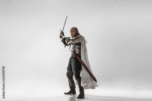 Schilderij op canvas Brave armored knight with professional weapon fighting isolated on white studio background