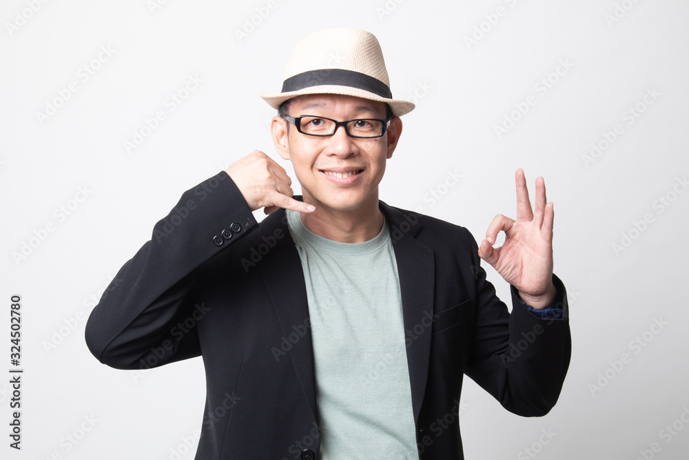 adult asian man show with phone gesture and OK sign. adult asian man show with phone gesture and OK sign.