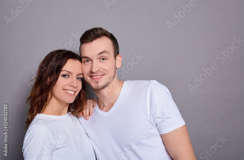 Cheerful smiling couple in love cuddling.