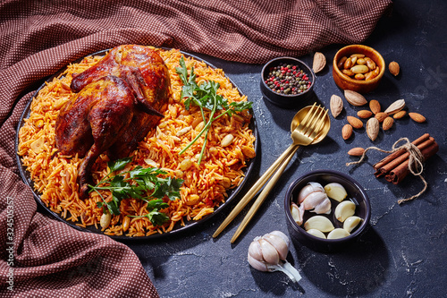 Saudi arabian kabsa - spiced chicken and rice photo