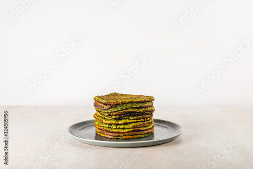 Healthy green pancakes made from spinach, coconut milk, banana and oats. Vegetarian and gluten free breakfast