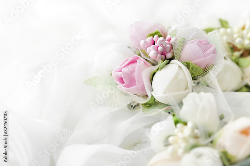 wedding flowers on bridal dress folds