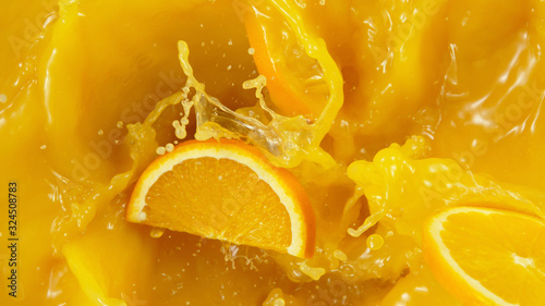 Detail of falling orange slices in juice