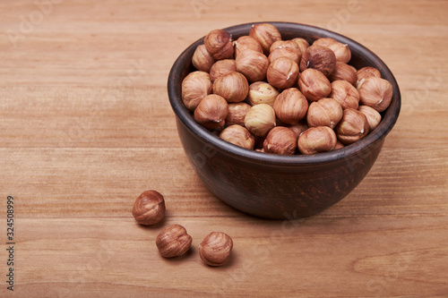 Walnut kernels and whole walnuts on rustic old wooden table