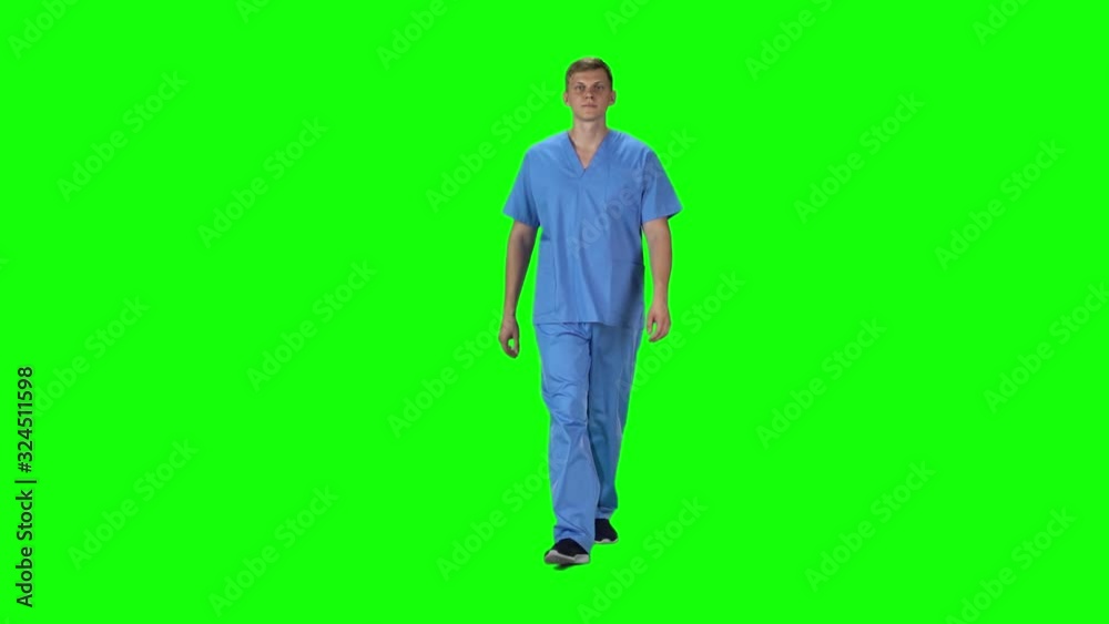 Medical man going and looking forward against a green background. Slow motion. Medical man going and looking forward against a green background. Slow motion.