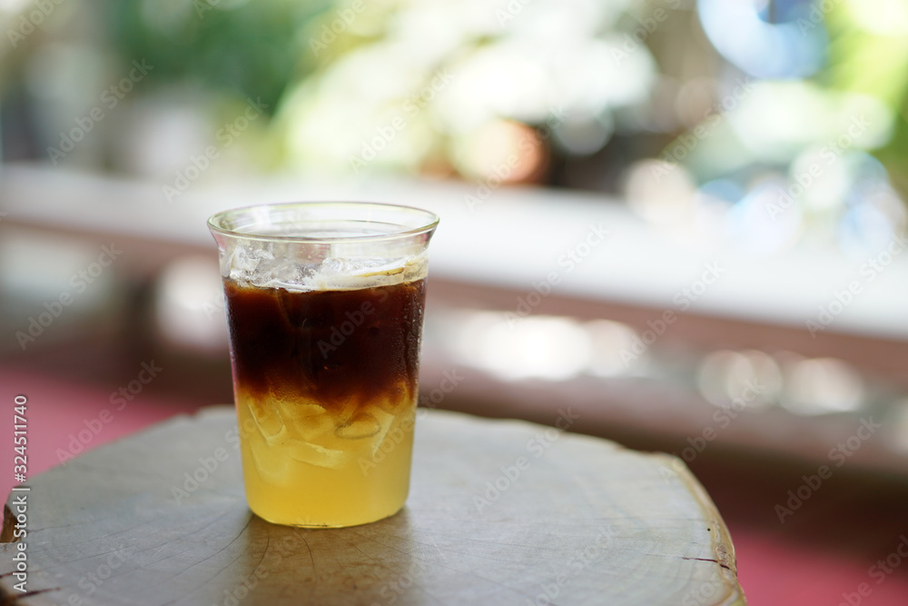 Iced coffee with orange - A glass of espresso shot mixed with orange juice and craft soda on blurred background and copy space, Perfect drink for summer time. Iced coffee with orange - A glass of espresso shot mixed with orange juice and craft soda on blurred background and copy space, Perfect drink for summer time.
