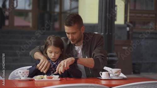 dad with his daughter in a coffee shop, a walk on the weekend, family vacations