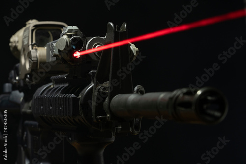 Canvas Print Optical sight and laser device with a red beam on the M4 rifle