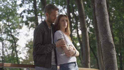 Beautiful couple on an alley in the park, date, walk