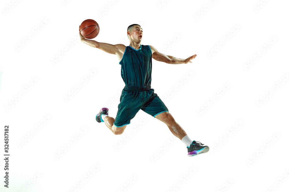 Young basketball player of team wearing sportwear training, practicing in action, motion in jump, flight isolated on white background. Concept of sport, movement, energy and dynamic, healthy lifestyle