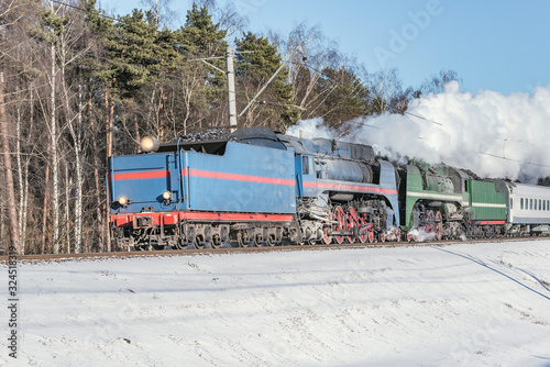Retro train moves at winter day time.
