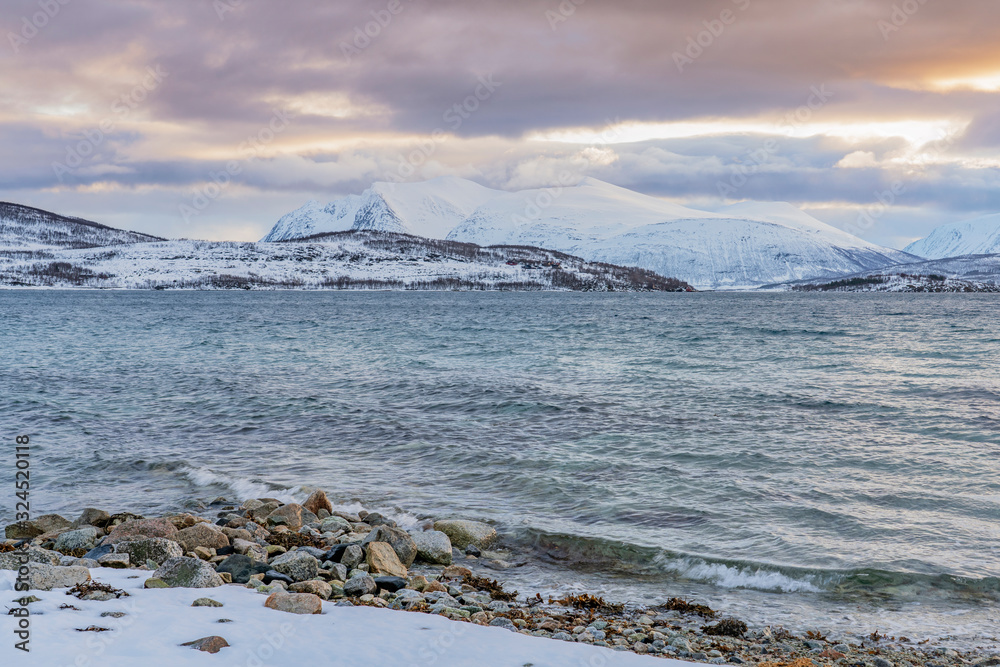 winter landscape at polar dawn on Kvaløya Island and fjord near Tromso, northern Norway winter landscape at polar dawn on Kvaløya Island and fjord near Tromso, northern Norway