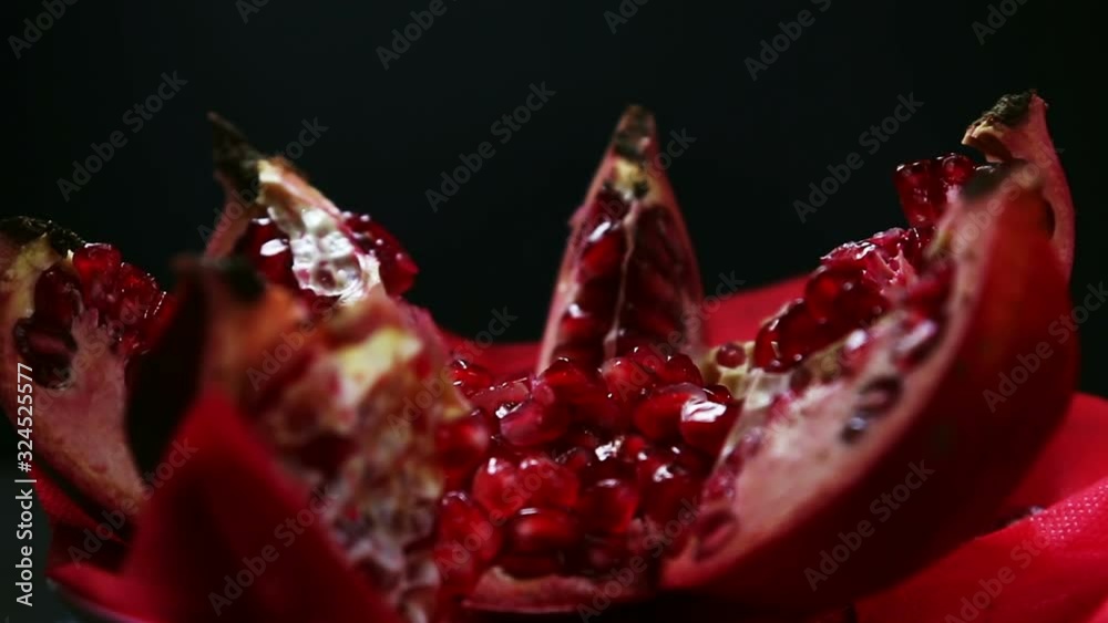 ripe pomegranate fruit with bright maroon grains. Garnet color. Rotation video